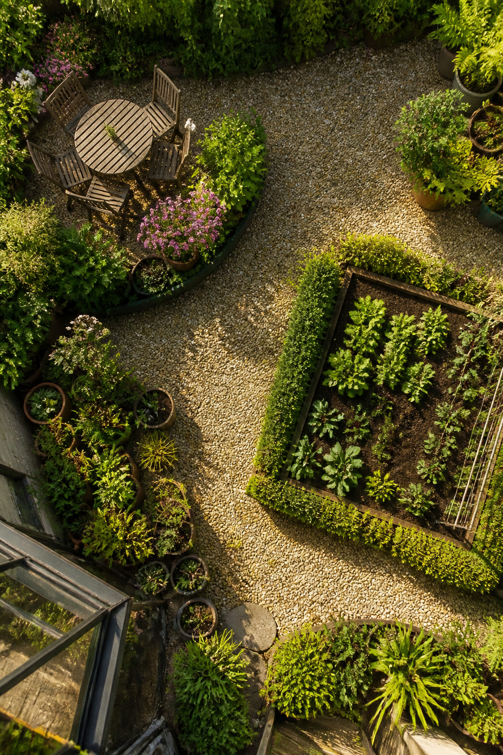 A small garden with distinct zones for sitting and growing.