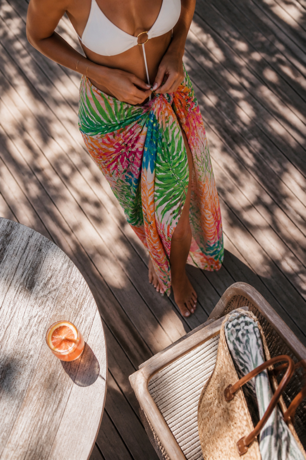 A tied sarong displayed on a wooden rack.
