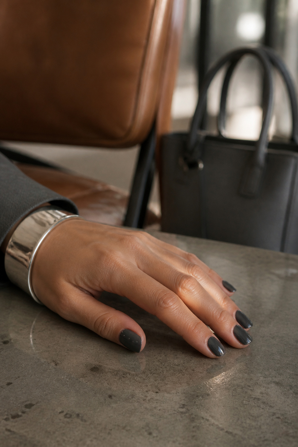20 Fall Nail Ideas for 2026: Colors, Shapes & Textures 10 Charcoal grey nails displayed in an office setting.