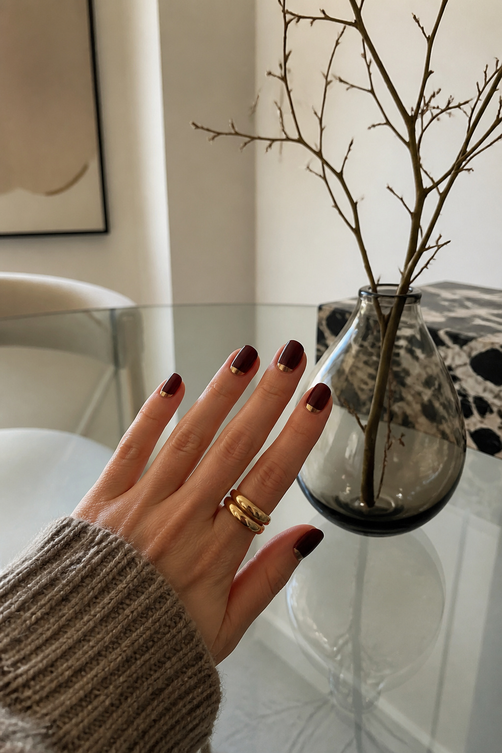 20 Fall Nail Ideas for 2026: Colors, Shapes & Textures 16 Reverse French nails with a metallic accent on a glass table.