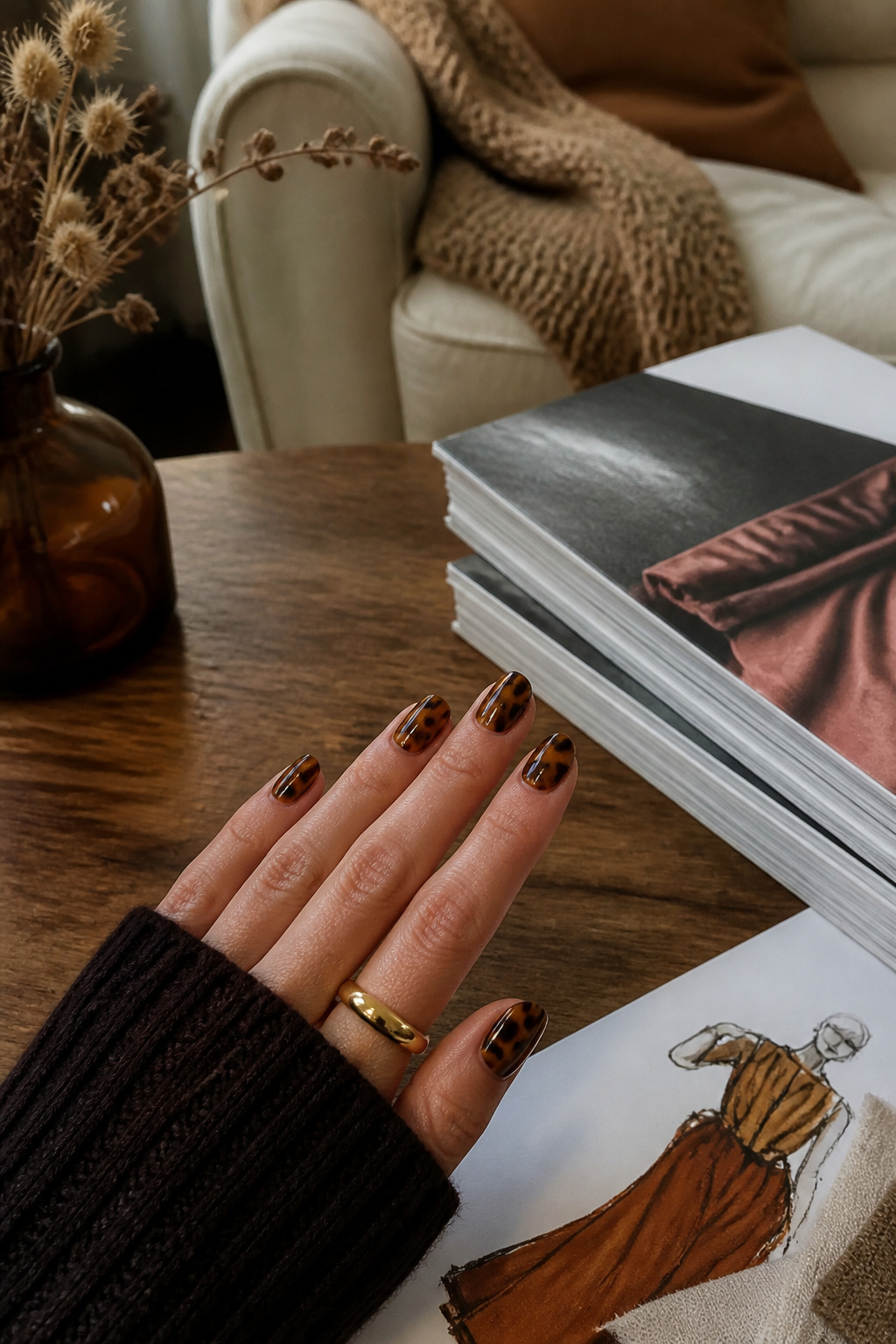 20 Fall Nail Ideas for 2026: Colors, Shapes & Textures 4 Close-up of tortoiseshell accent nails on a wooden table.