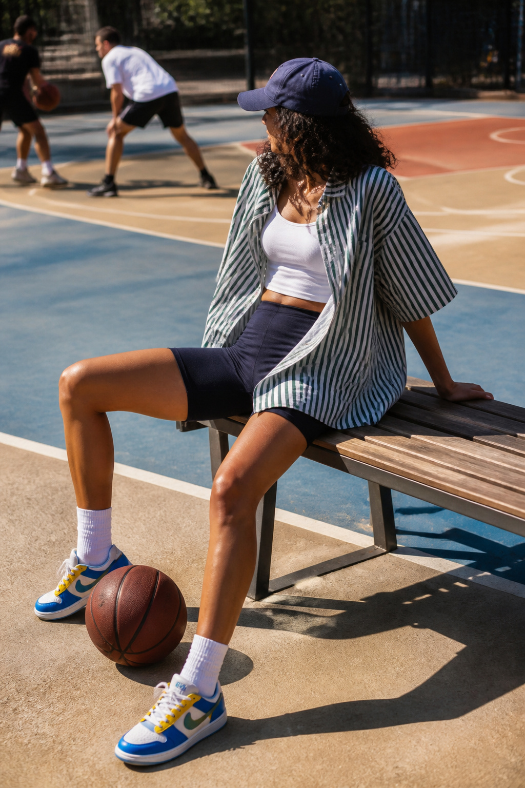How to Style Oversized Shirt: 15 Wearable Outfit Ideas for 2026 12 Model wearing an oversized graphic shirt over fitted gym shorts.