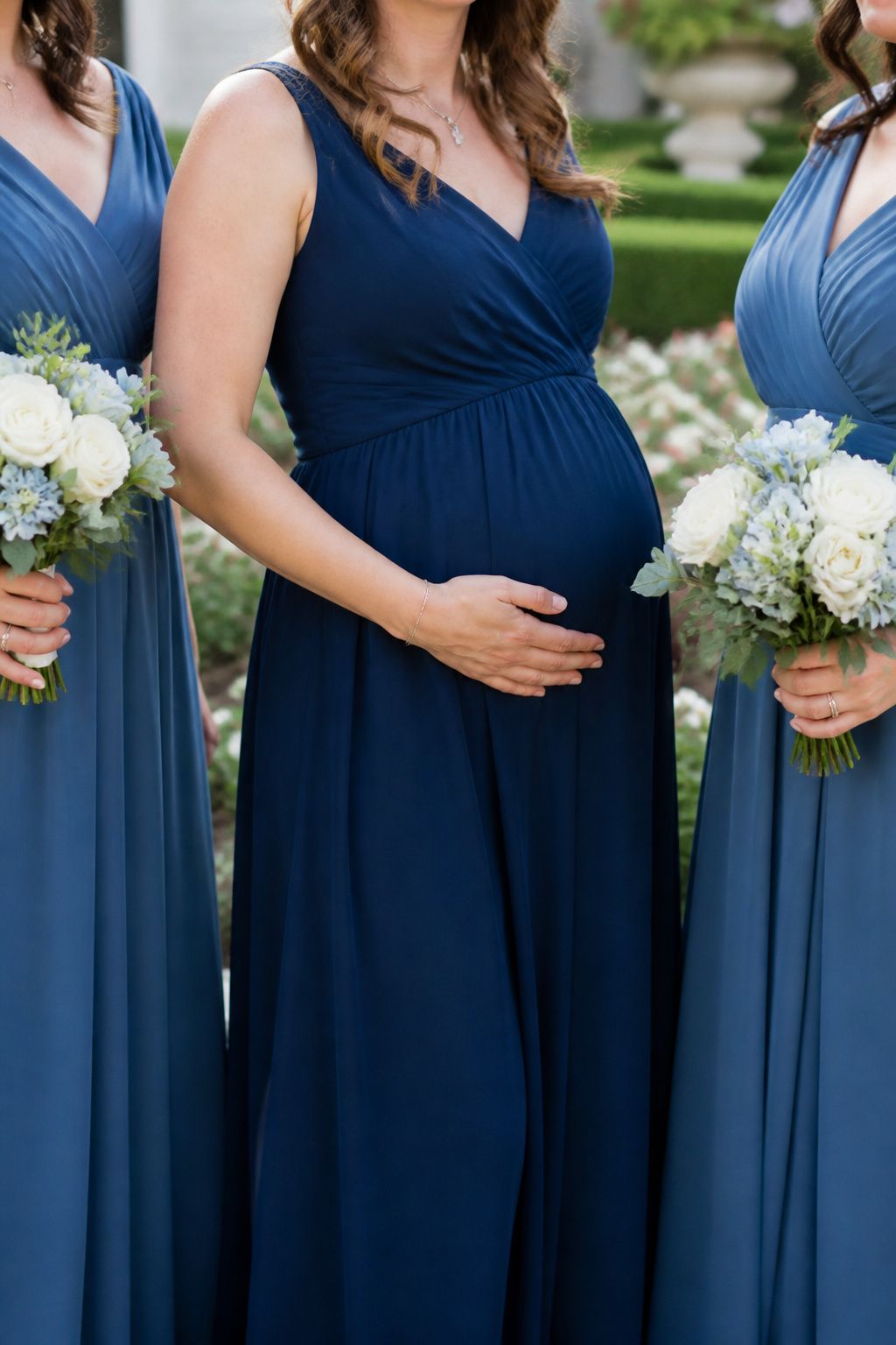 Maternity Dresses: Styles for Every Stage and Occasion 18 Expectant mother in a nursing bridesmaid dress at a wedding.