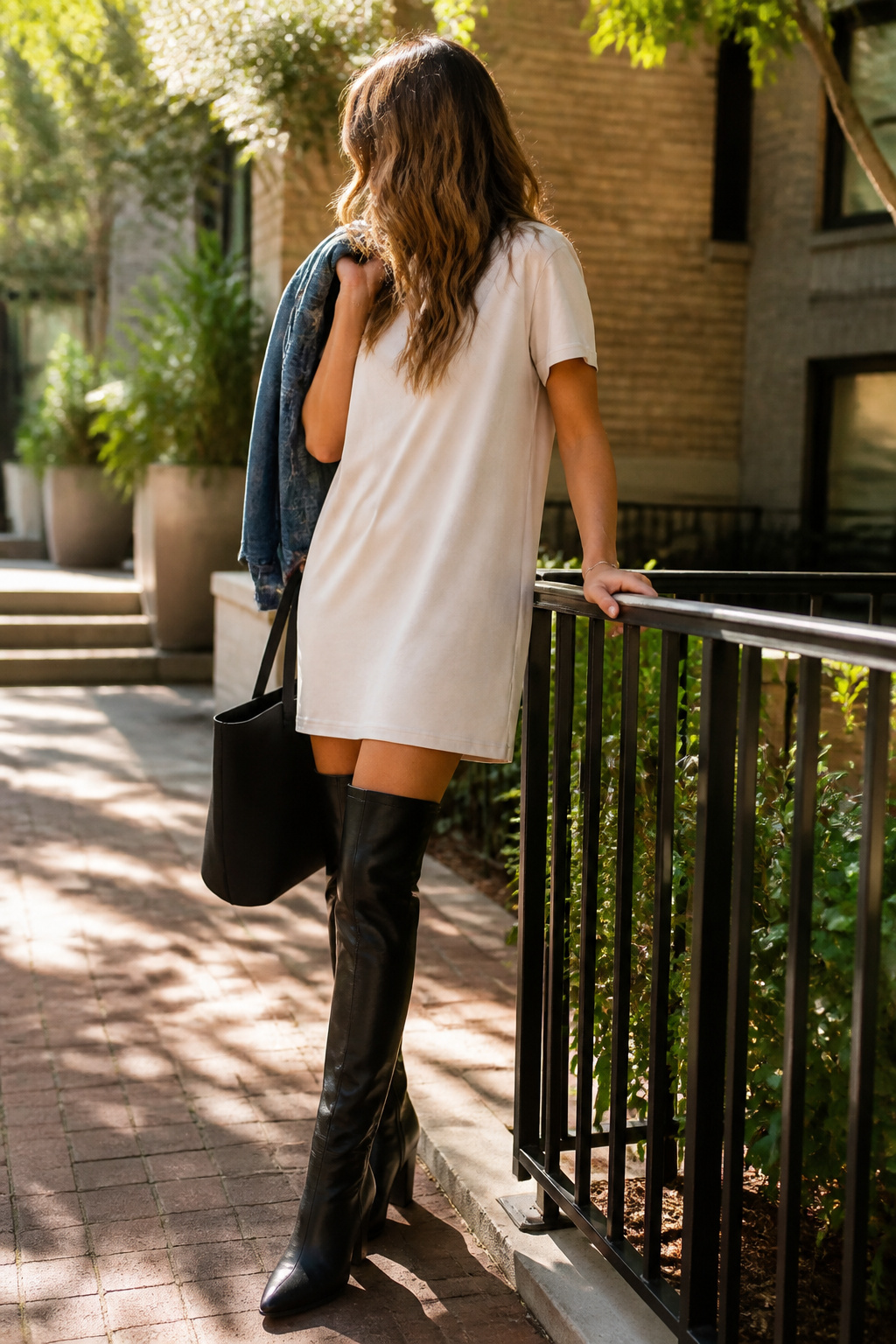 21 Over the Knee Boot Outfits for 2026 13 Beige t-shirt dress paired with black over-the-knee boots.