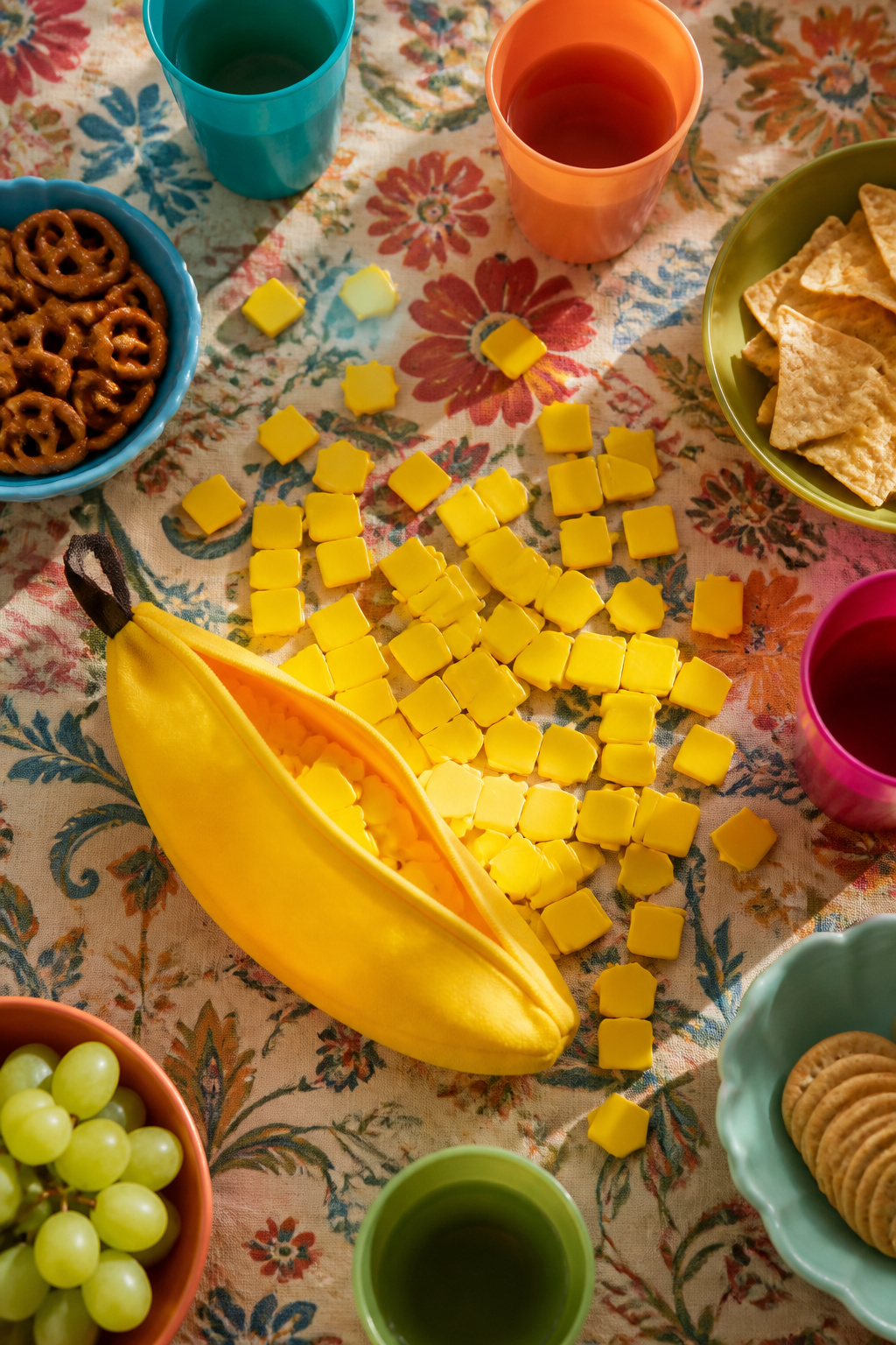 A bright yellow pouch of Bananagrams with banana-shaped tiles.