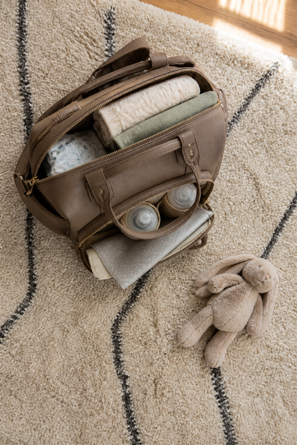 Newborn Essentials for Winter: What to Buy for Cold Weather 14 Diaper bag packed for winter outings, featuring insulated pockets.