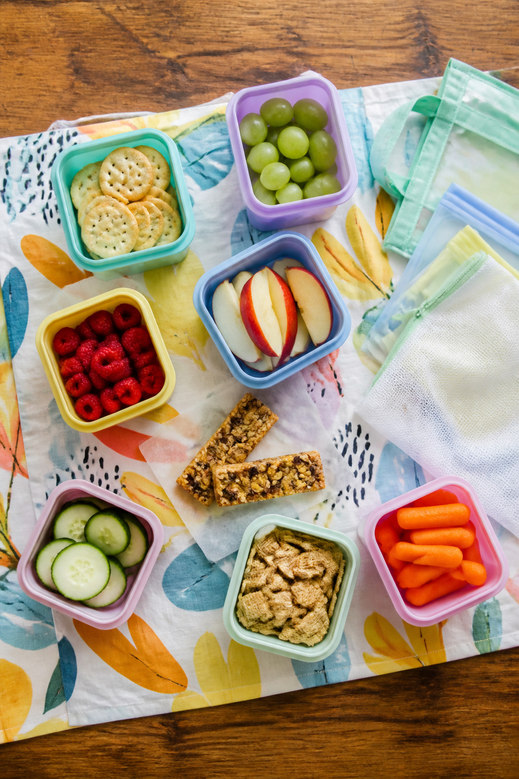 An assortment of healthy snacks displayed in reusable containers.