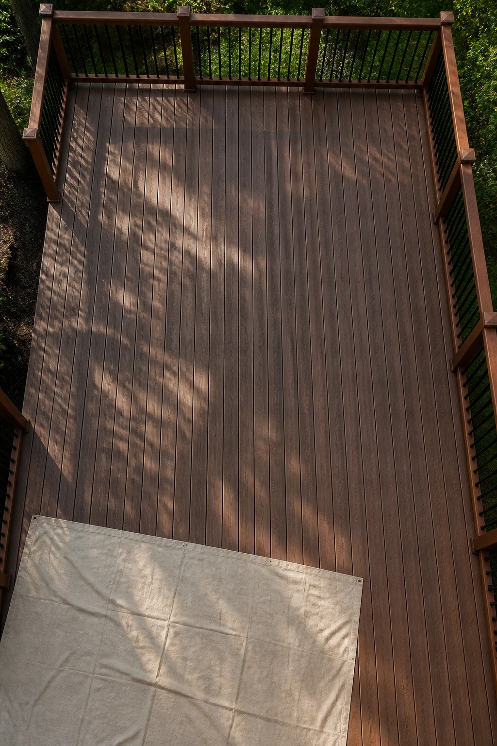An empty composite deck ready for cleaning, with no furniture present.