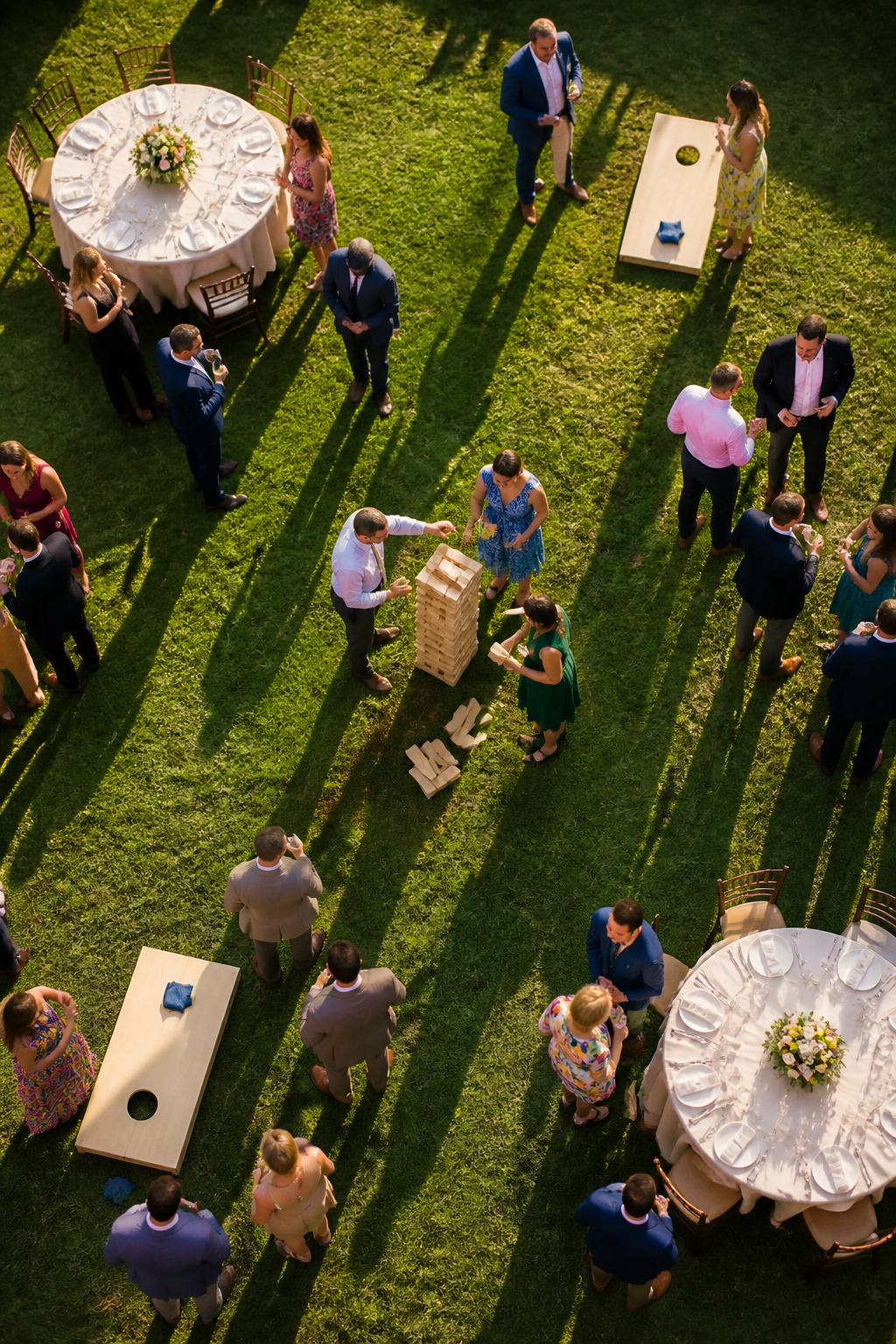 Guests playing cornhole at a wedding reception.