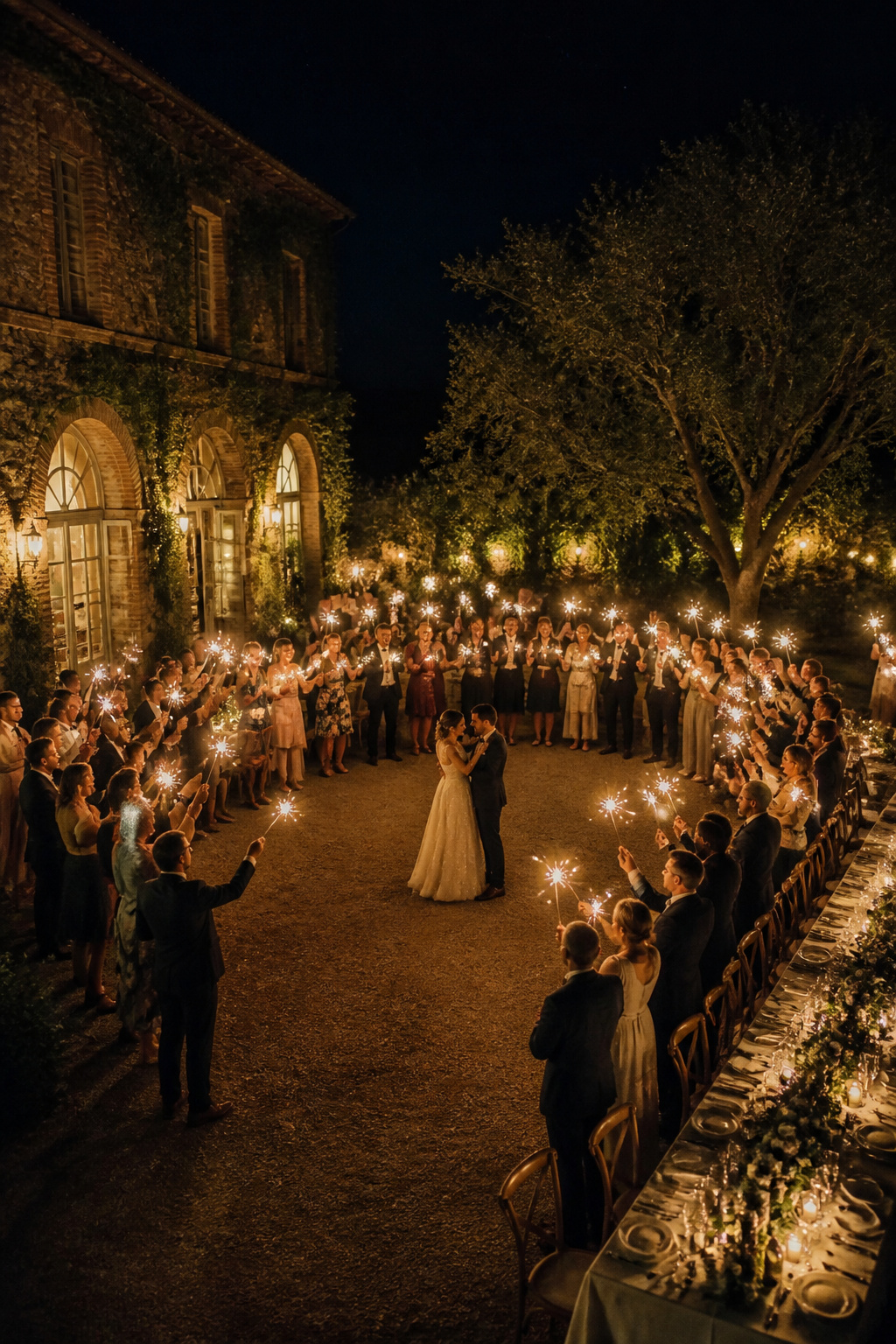 Guests with sparklers surrounding a couple during their first dance.