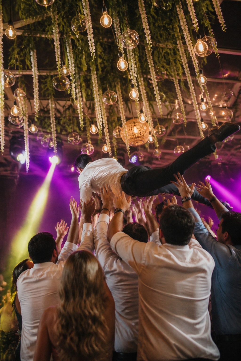 Guests crowd surfing at a wedding reception.