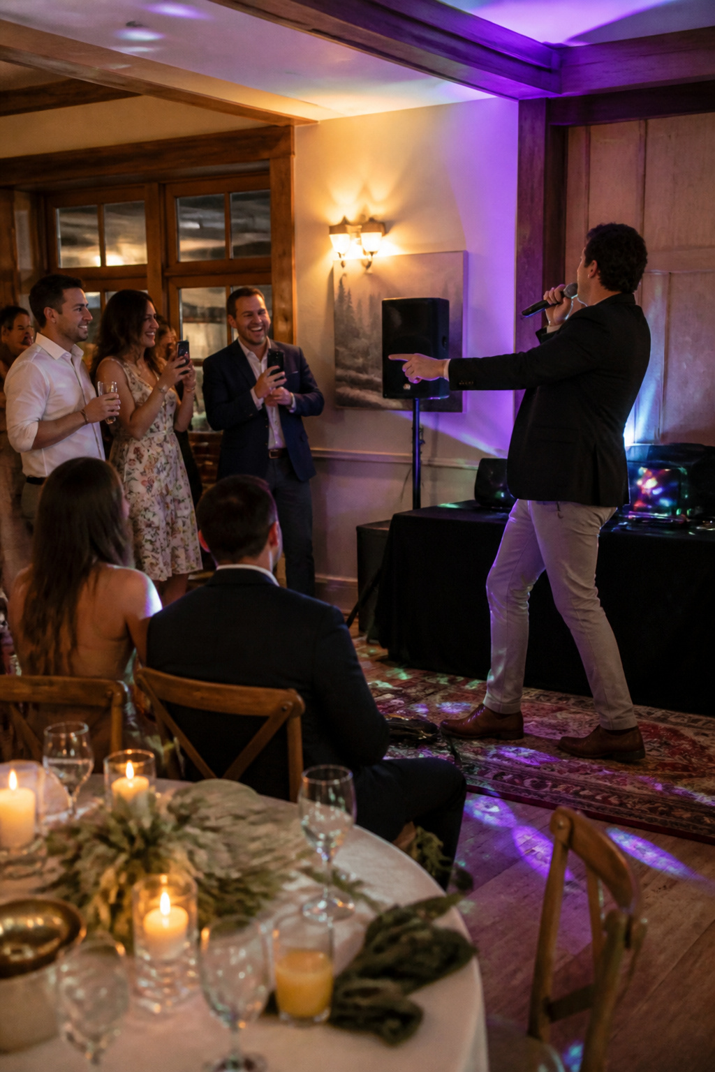 Karaoke machine with guests gathered around during a wedding.