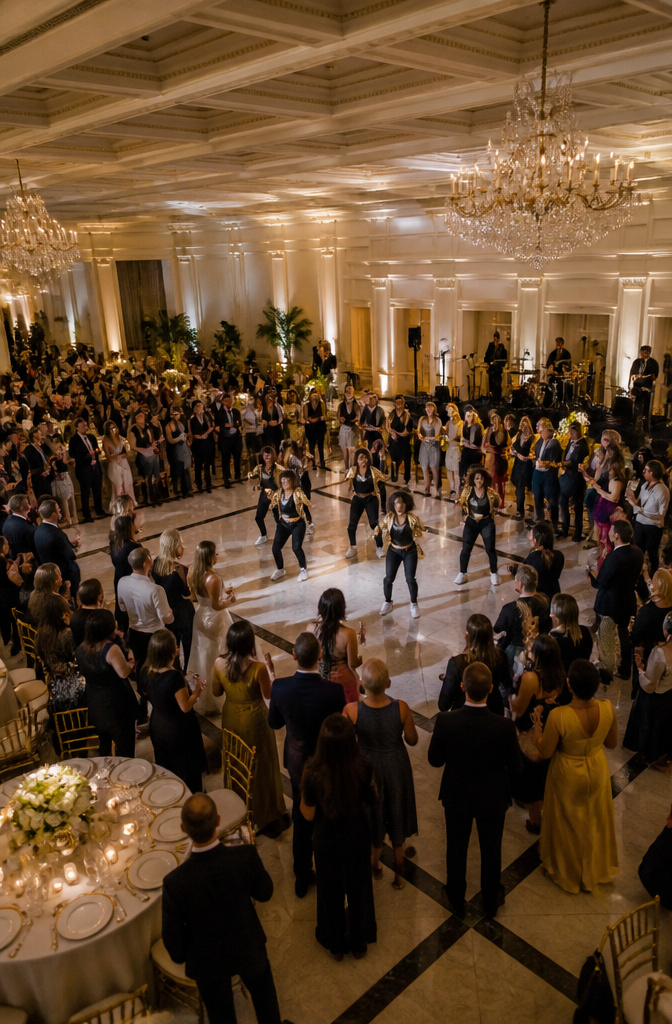 Wedding party members performing a surprise dance at a reception.