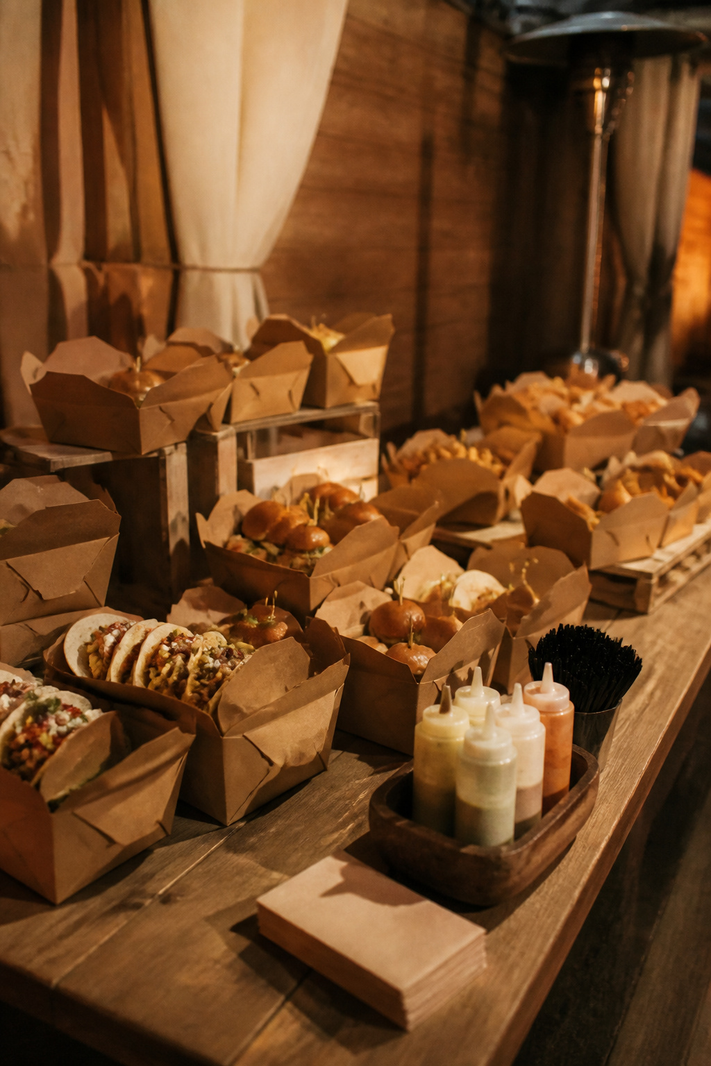 Branded boxes filled with mini tacos and sliders displayed.