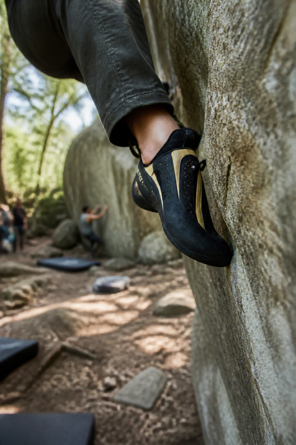 Evolv Phantom climbing shoe on a steep boulder.
