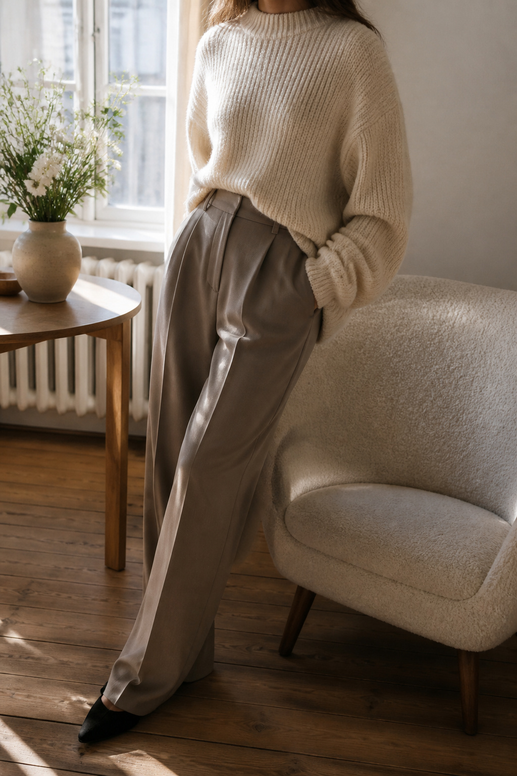 A photograph of an oversized knit garment on a model.