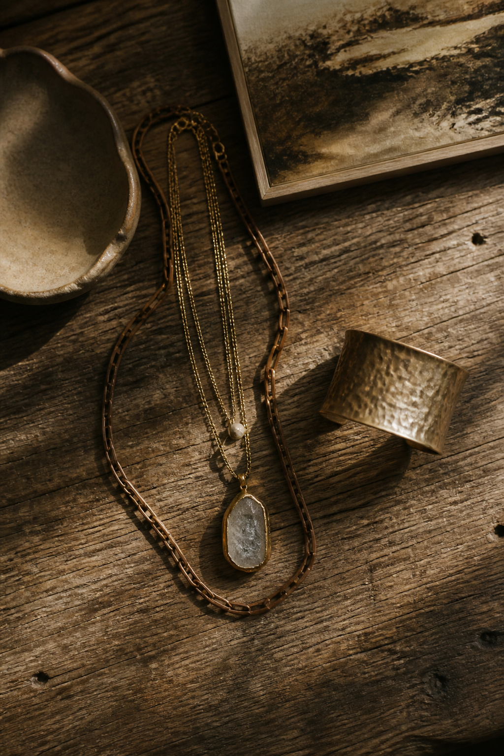 A collection of layered jewelry including wooden and metal pieces.