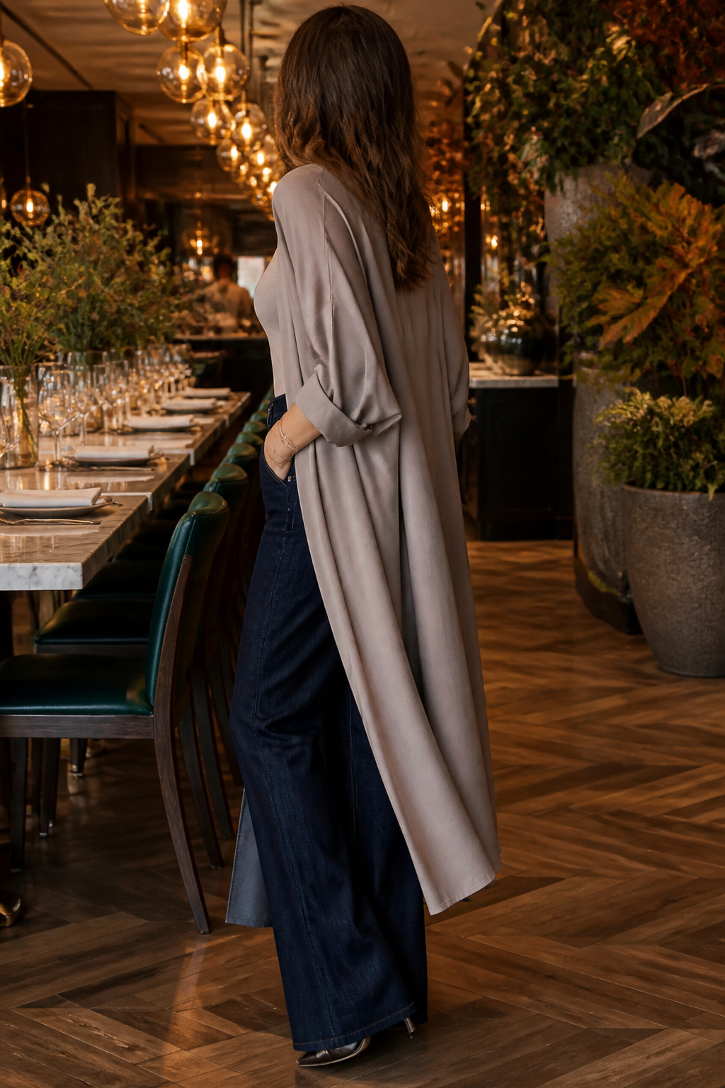 A ruffled duster top and wide-leg jeans displayed together.