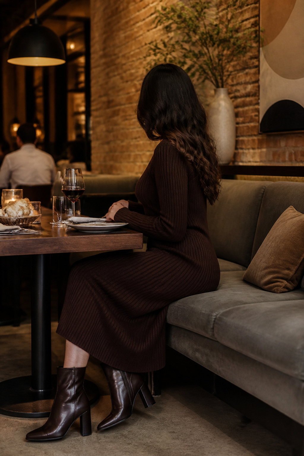 A cozy knit dress and ankle boots shown together.