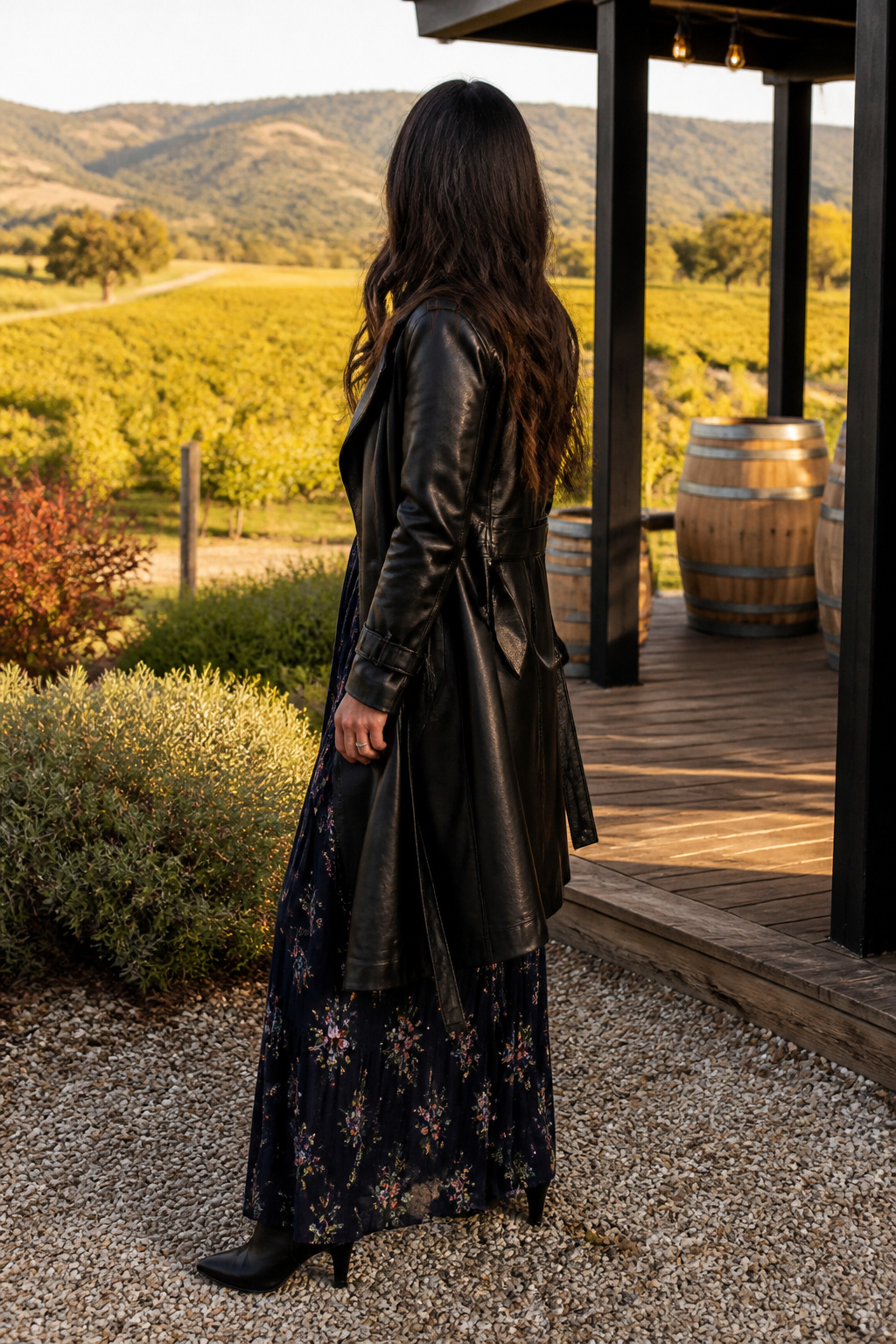 Maxi dress with floral pattern and black leather trench coat.