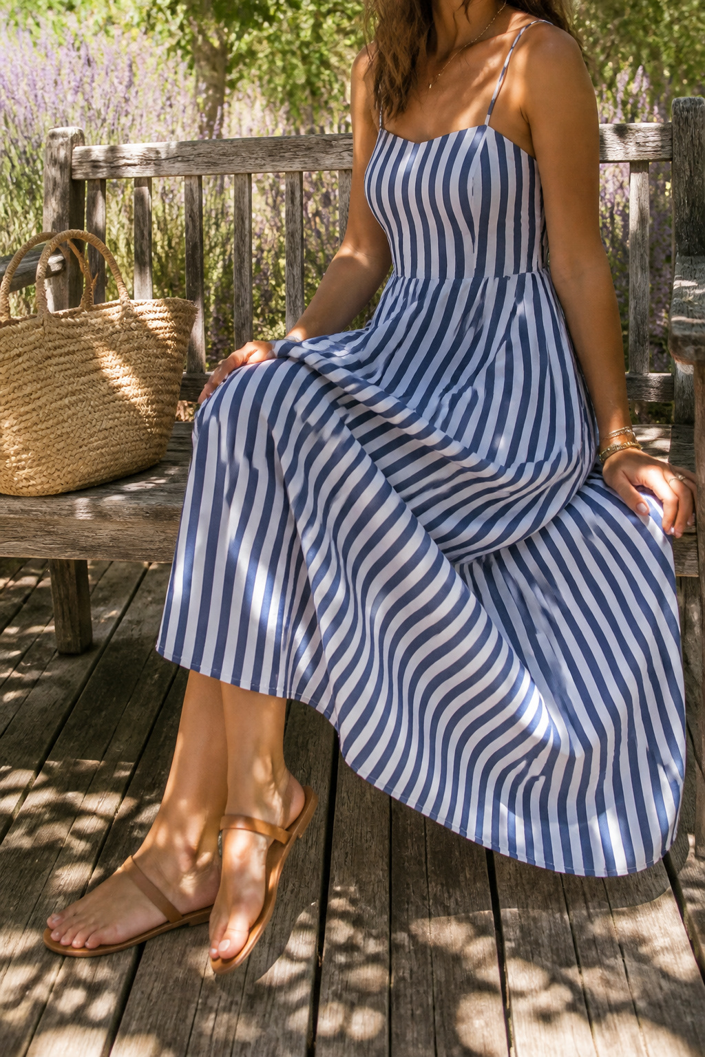 Striped summer dress on a textured wooden deck.