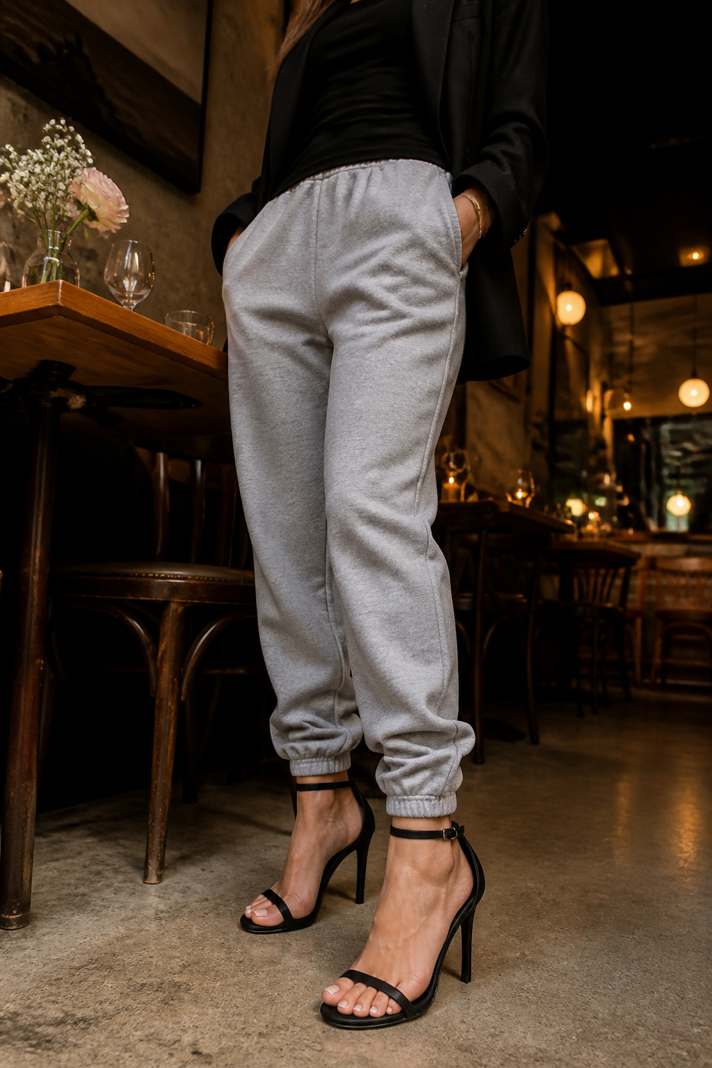 Black heels paired with gray sweatpants.