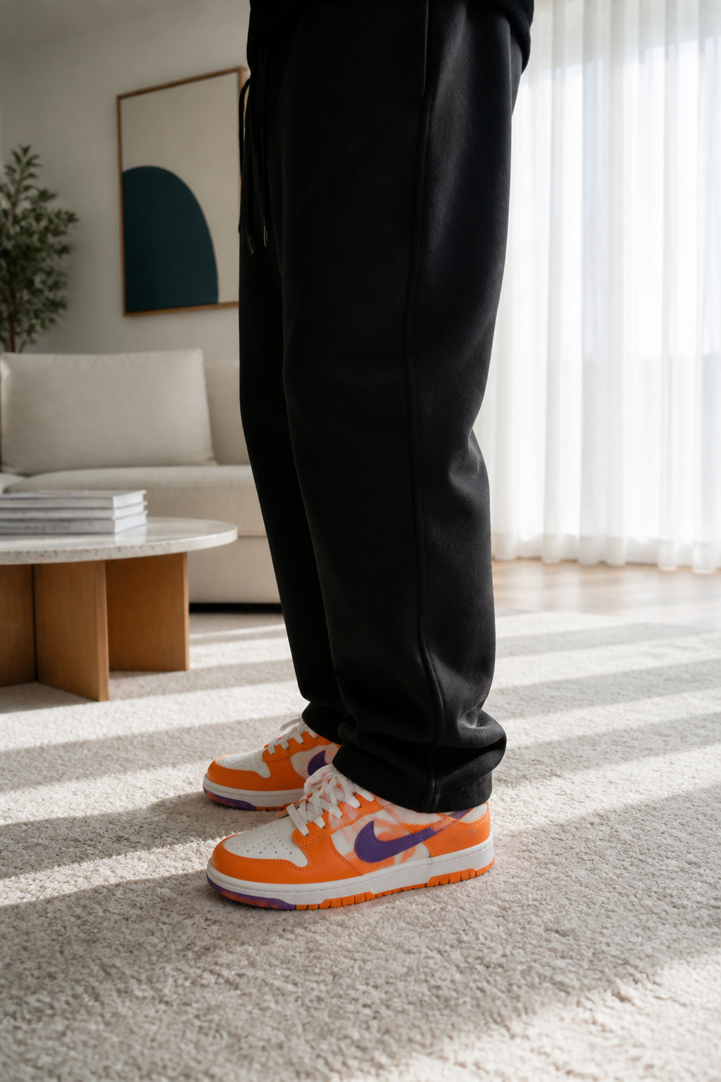 Colorful Nike Dunk sneakers with black sweatpants.