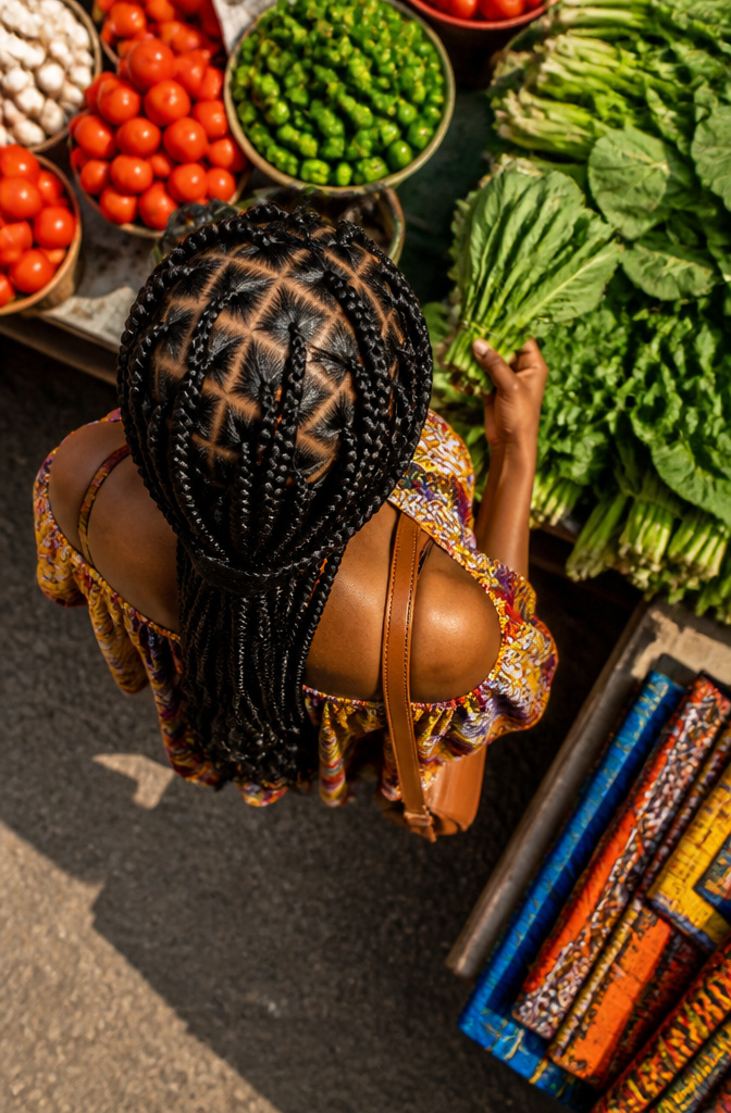 Woman showcasing criss-cross goddess braids in a beauty studio.