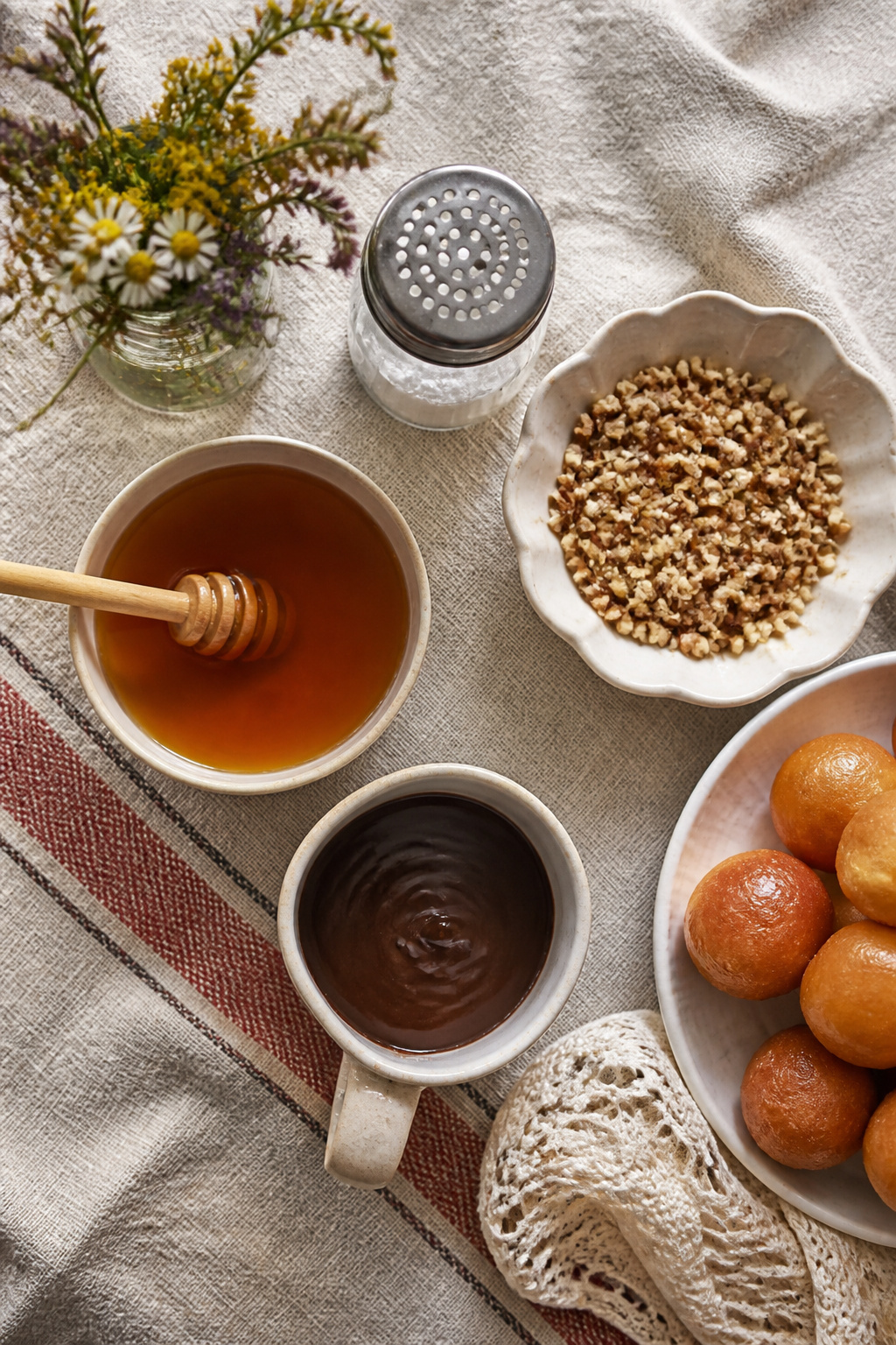 Loukoumades topped with honey syrup, cinnamon, and walnuts.