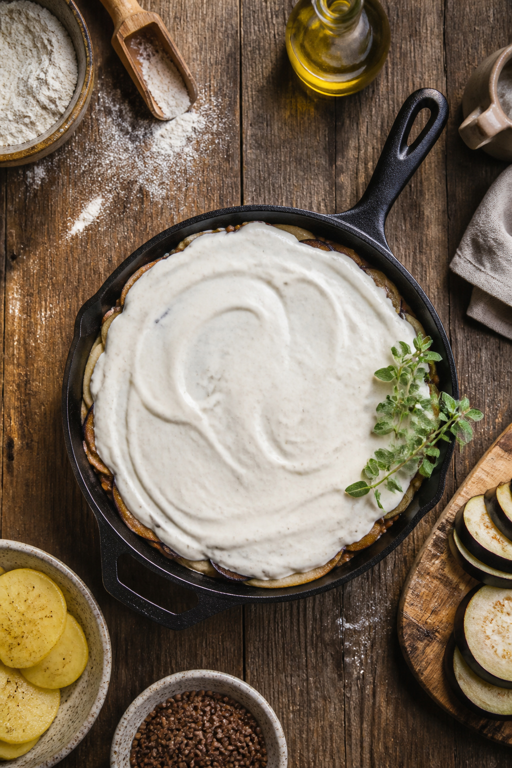 A baking dish layered with potatoes, lentils, and eggplant.