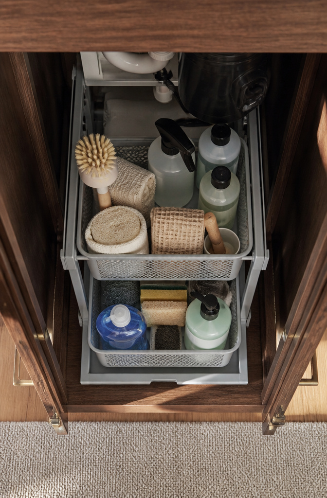 How to Organize Your Kitchen Sink Cabinet: 8 Ideas for 2026 12 Cleaning supplies arranged for easy access in an under-sink cabinet.