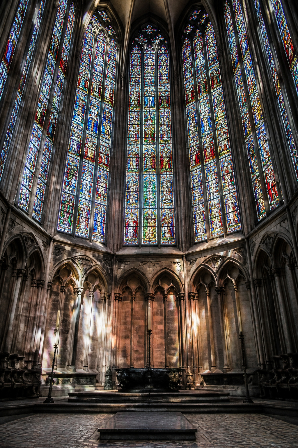 Stained glass windows showing biblical miracles at Cologne Cathedral.