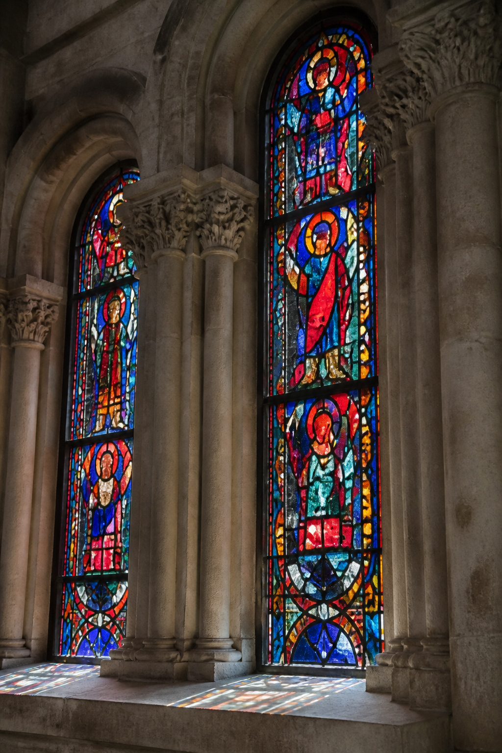 Romanesque stained glass windows depicting biblical figures in Augsburg Cathedral.