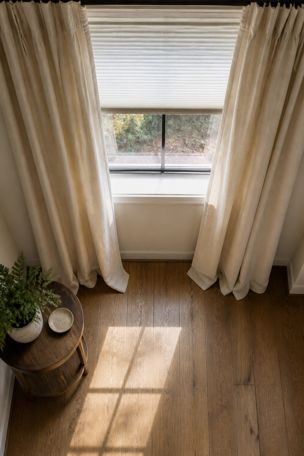Temporary pleated paper shades installed on a window.