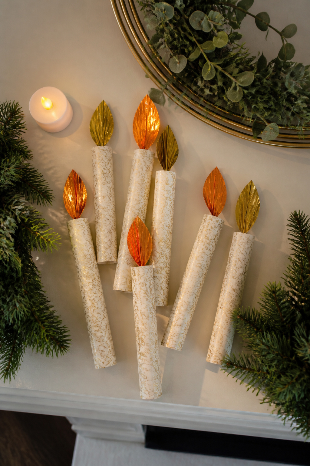 40 DIY Christmas Ornaments to Make in 2026 3 Paper tube candle ornaments with metallic cupcake liner flames.
