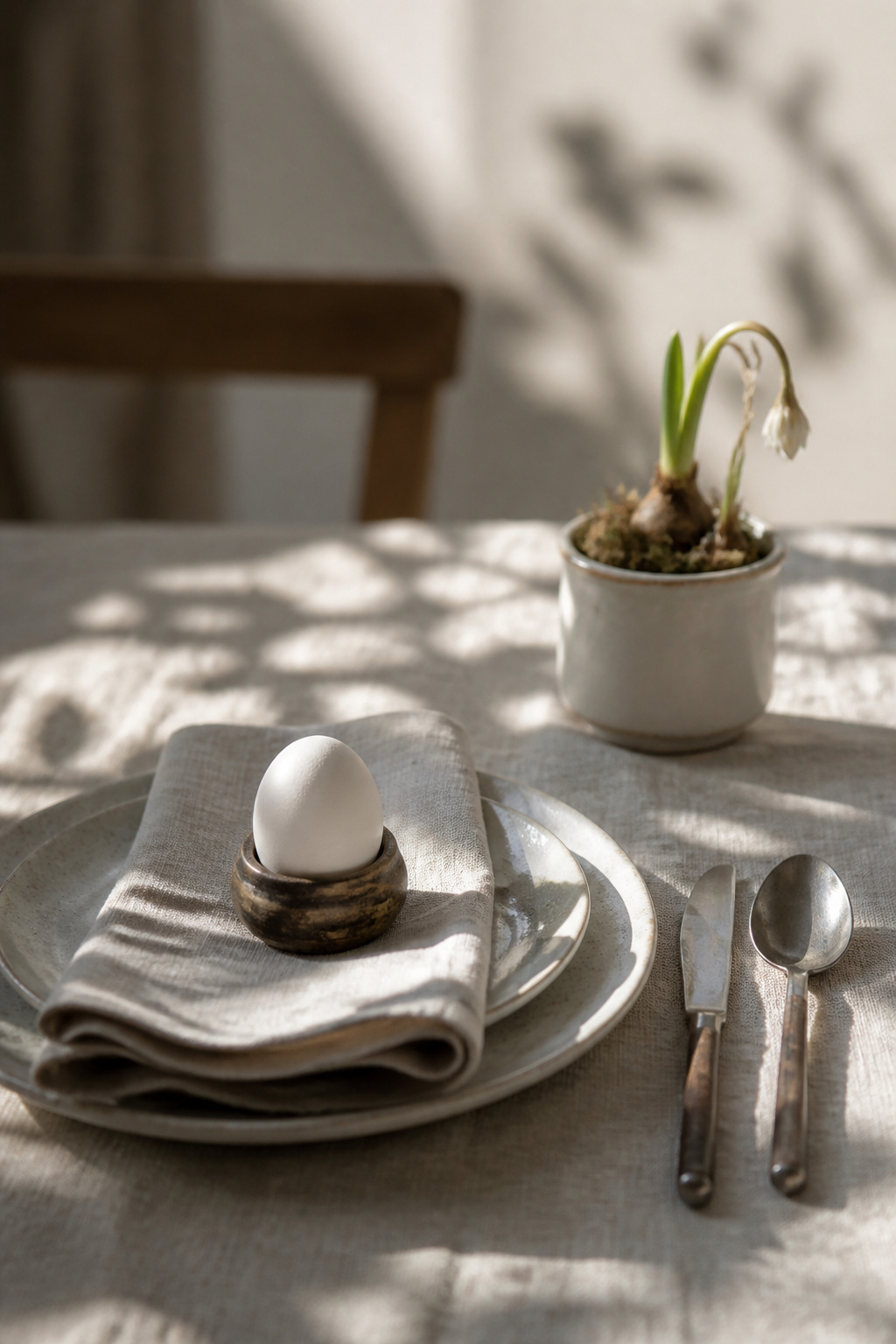 9 Easy Easter Decorating Ideas for a Budget-Friendly 2026 Home 9 Blown egg on a linen napkin ring at a table setting.