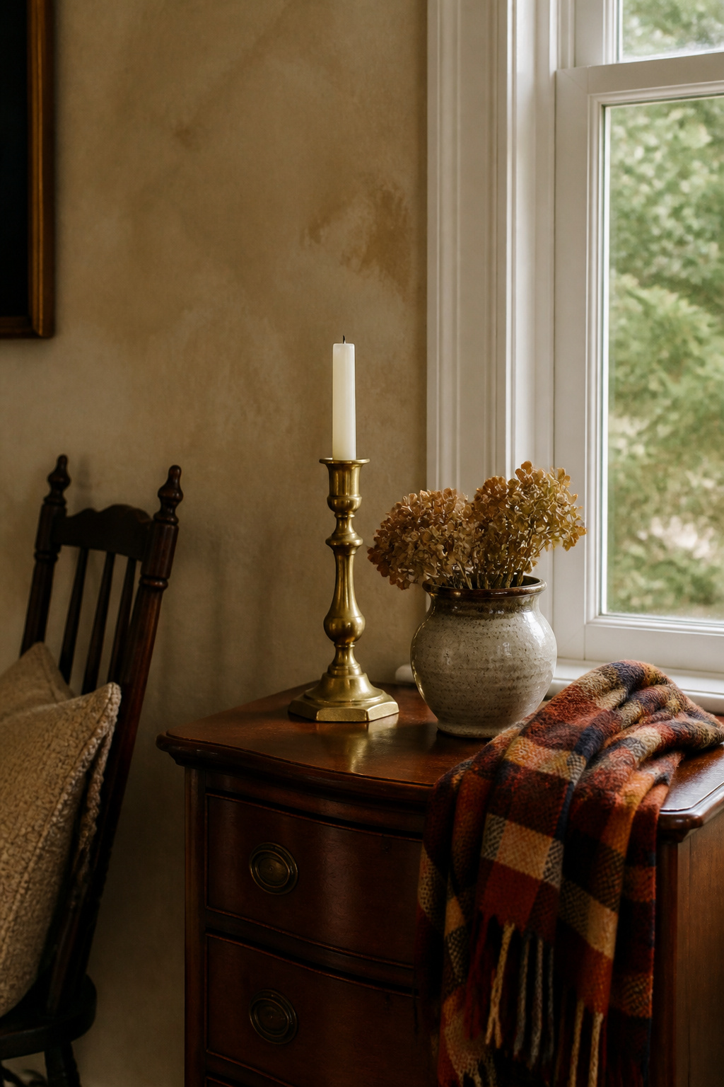 8 Easy Fall Decorating Ideas for a Cozy Home in 2026 3 A brass candlestick beside a handmade pottery piece on a side table.