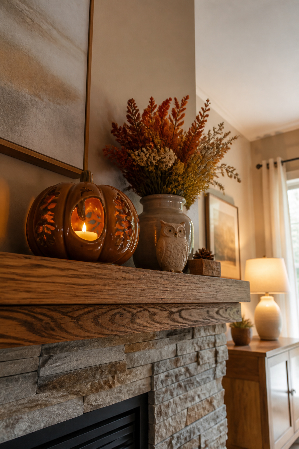 Fall Home Tour 2026: Six Ideas for Warm Autumn Style 5 Ceramic pumpkin with a candle on a chest near a window.