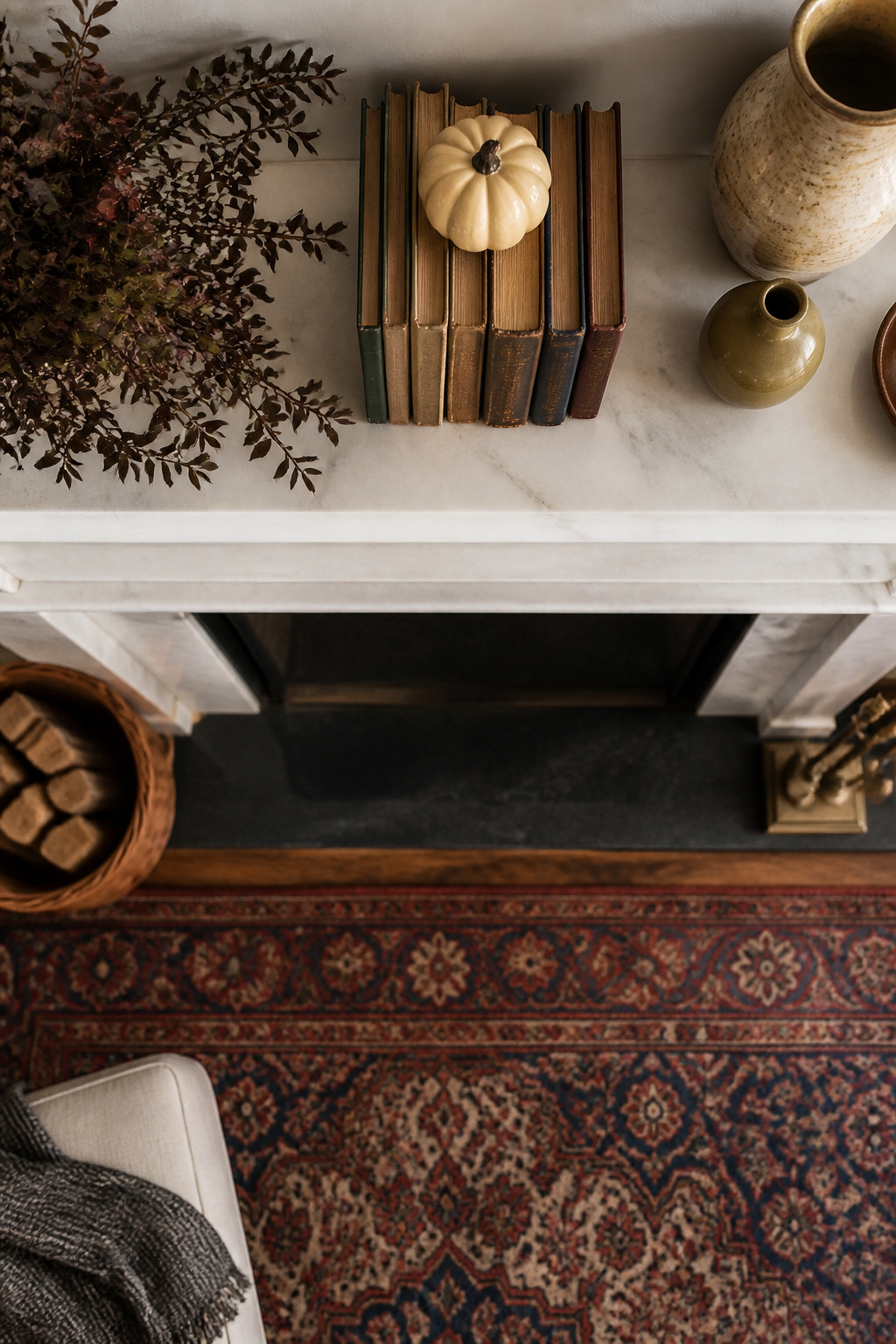11 Fall Mantel Decoration Ideas for a Styled Hearth 9 Books stacked horizontally on a mantel with decorative items.