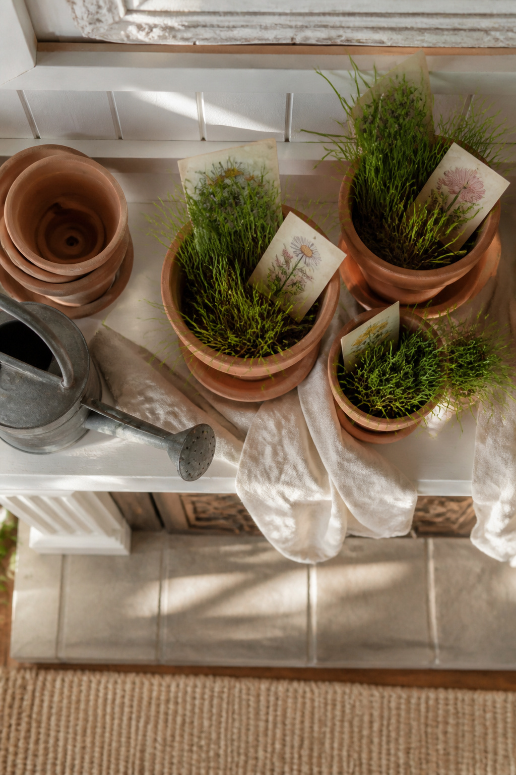 8 Spring Mantel Ideas for 2026: Rustic, Floral, Easter, Minimalist & More 7 A mantel displaying terracotta pots filled with faux grass and seed packets.