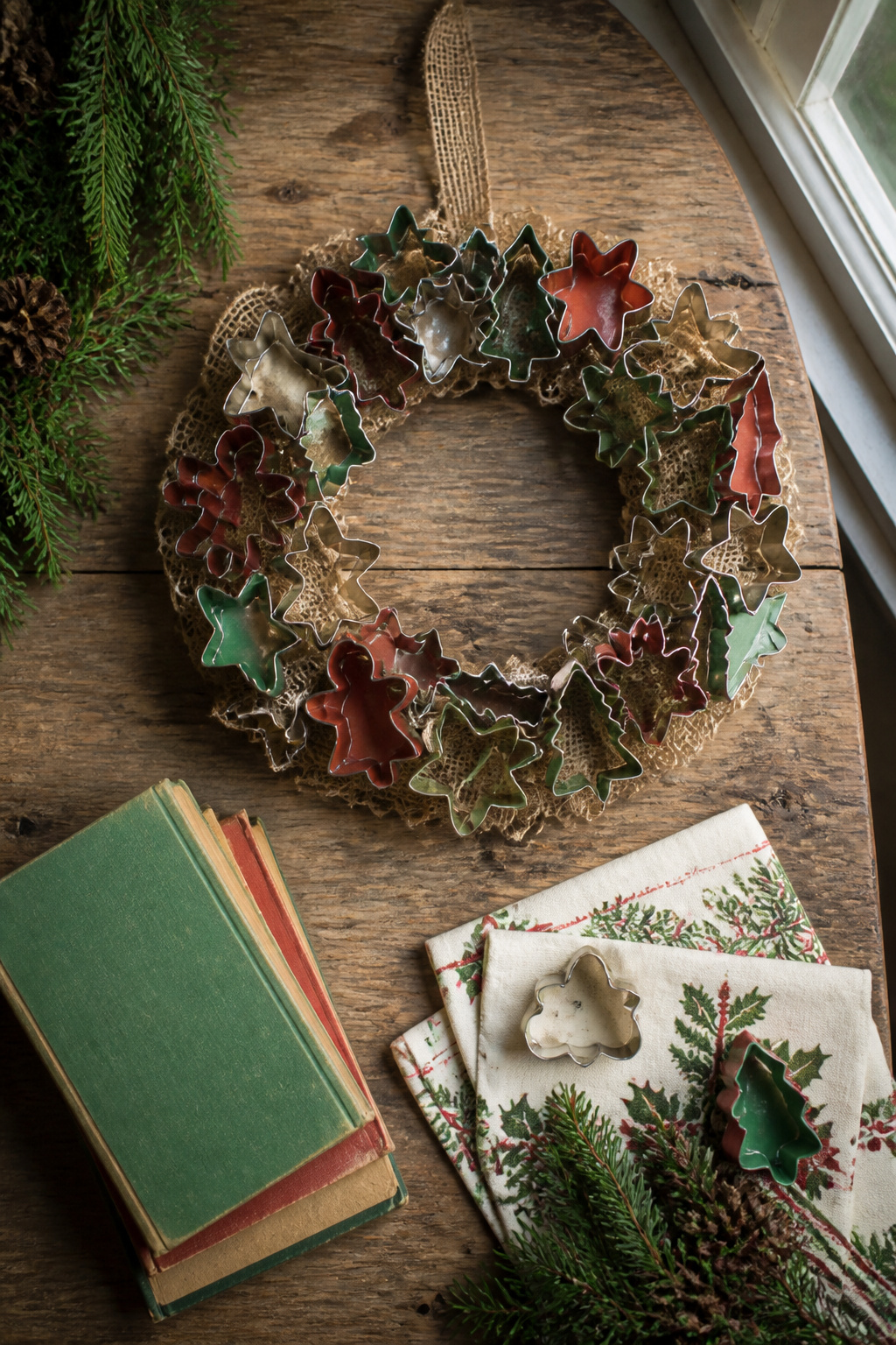 Vintage Christmas Display: Ornaments, Trees, Cards & Ephemera 6 A wreath made from vintage cookie cutters hanging on a wall.