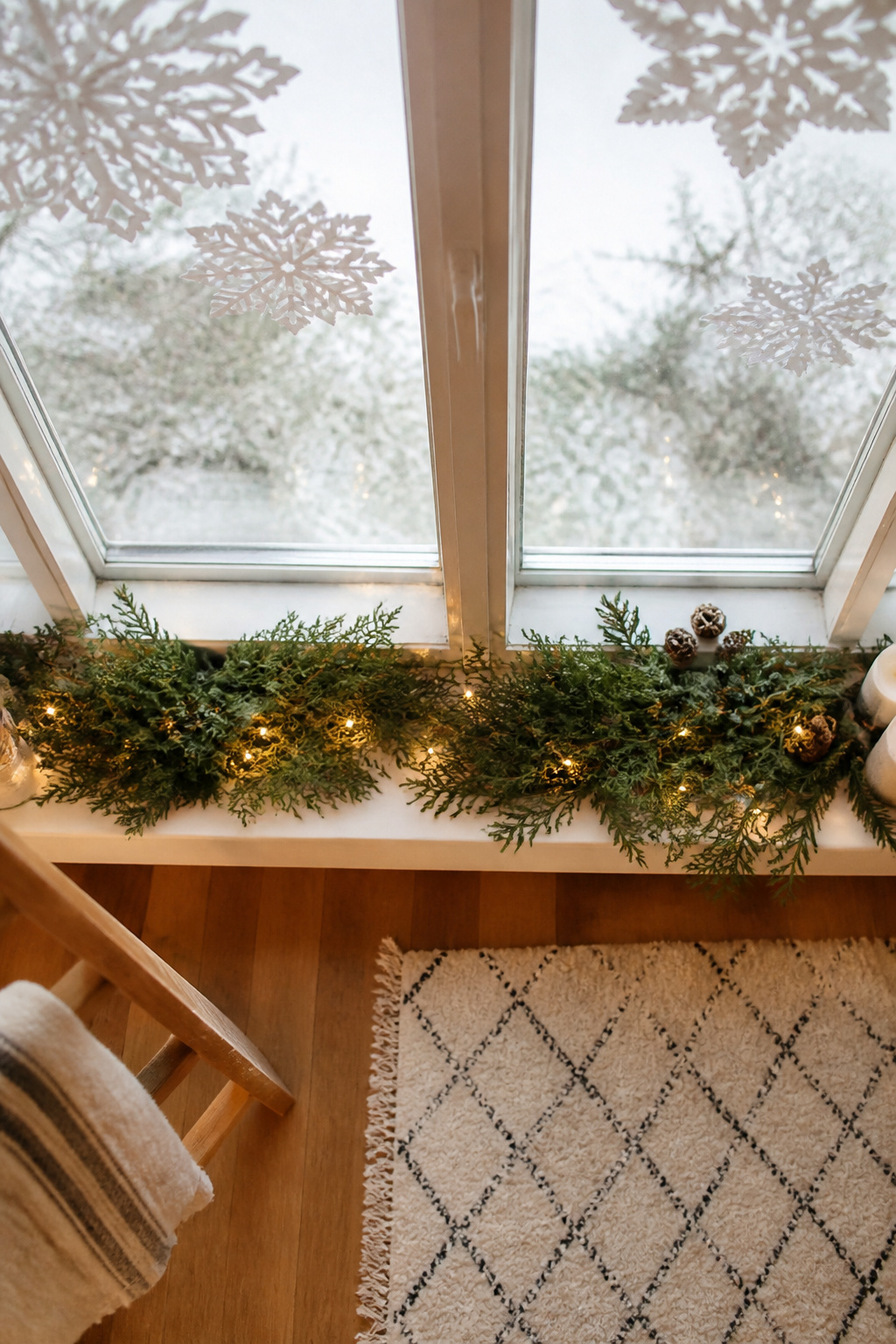 10 Christmas Window Sill Decorations for 2026: A Complete Guide 7 Paper snowflakes hanging from a window sill, made from various types of paper.