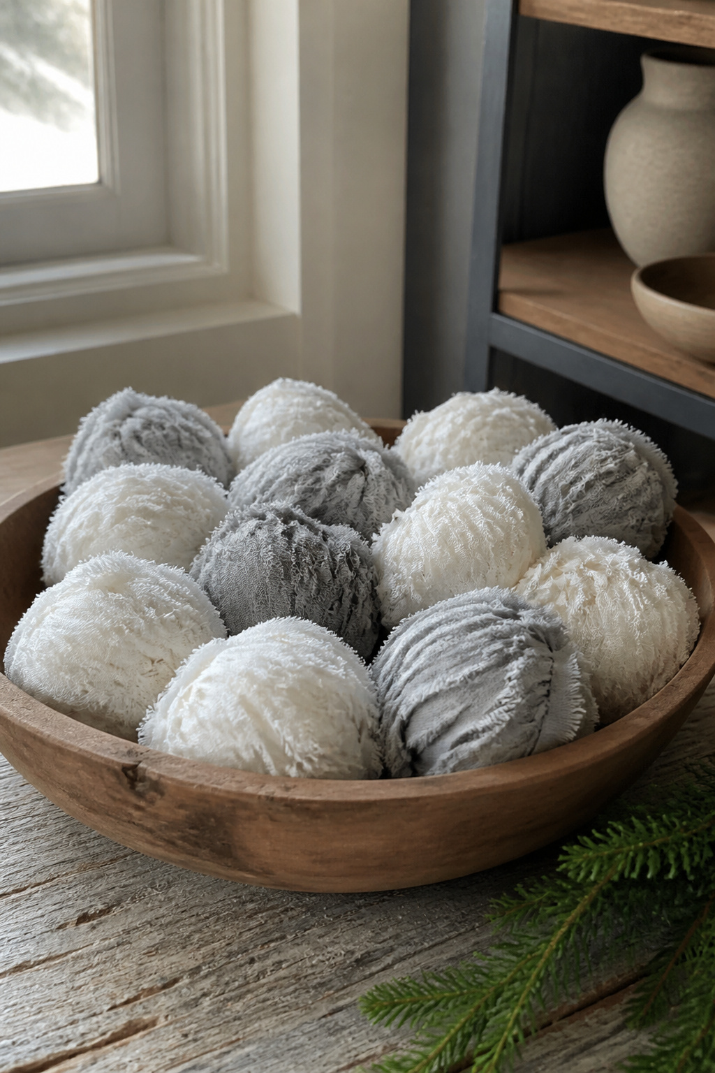 10 Winter Crafts for Adults to Make in 2026 1 A bowl filled with DIY Fabric Snow Balls made from muslin and flannel.