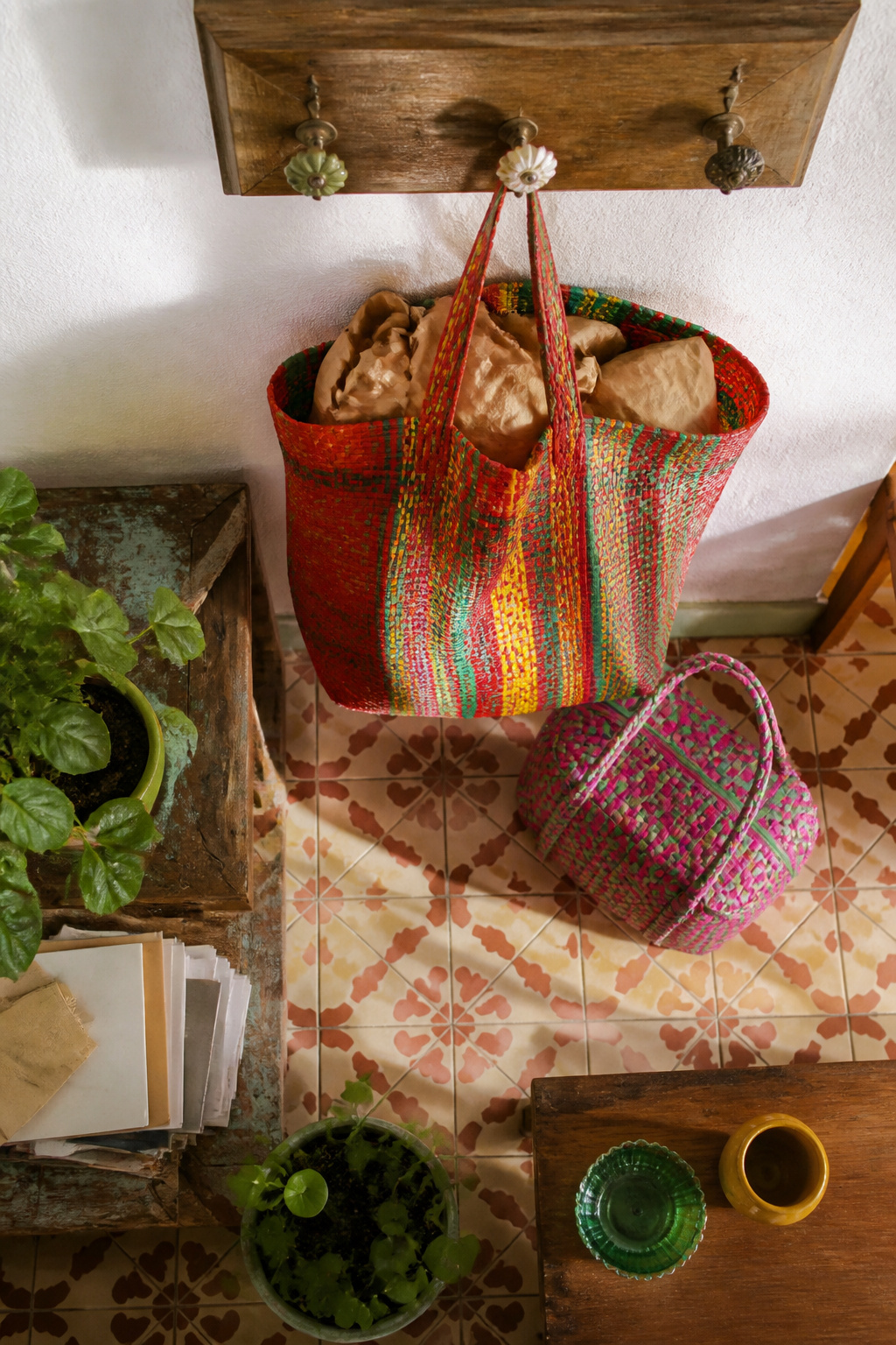 A display of small and large woven market bags in vibrant colors.