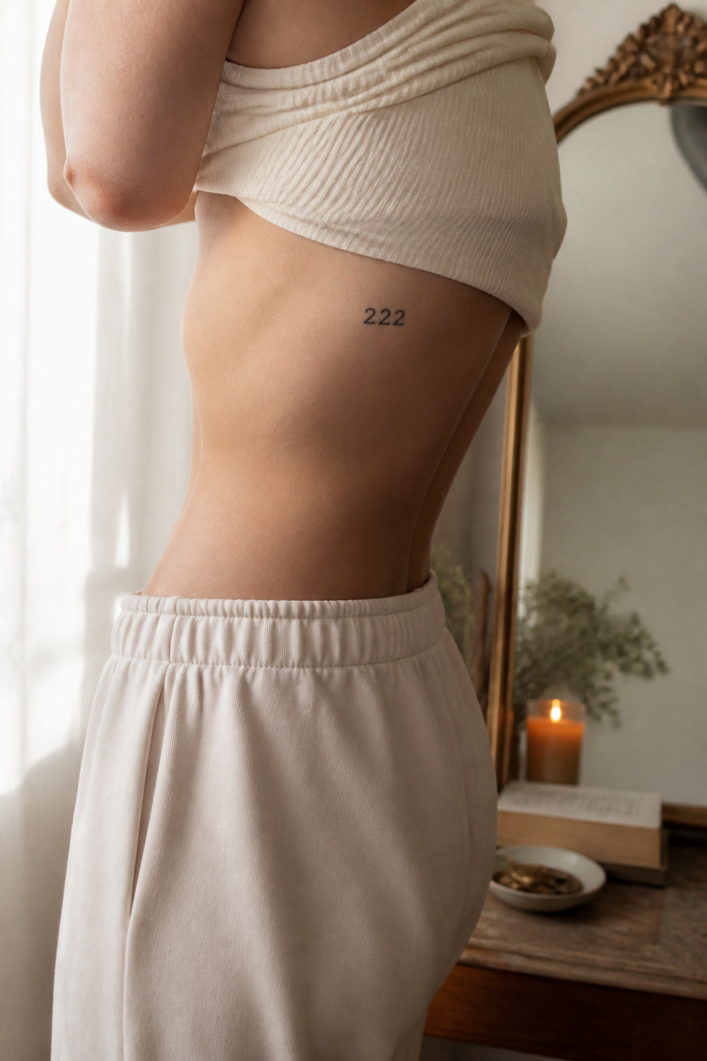 A clear '222' tattoo inked on the side of a torso.