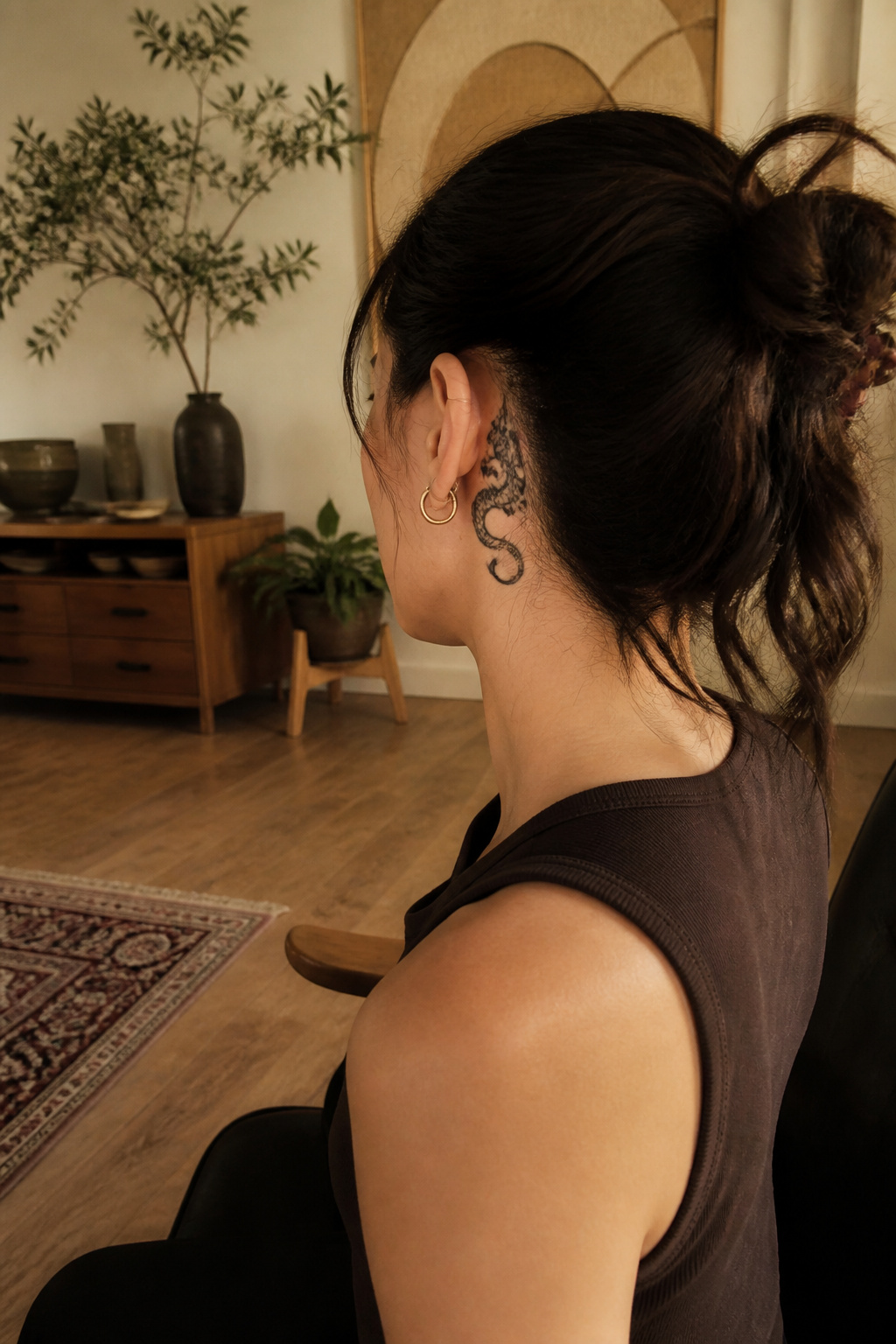 Dragon tattoo wrapping around the ear's cartilage.