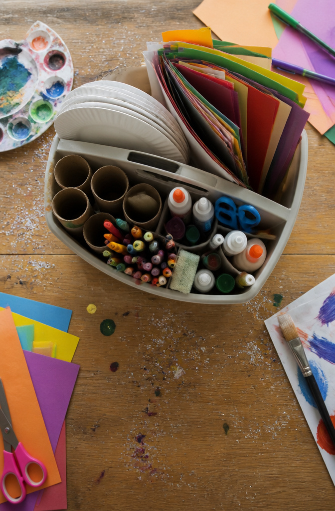 A collection of basic craft supplies including paper plates and googly eyes.