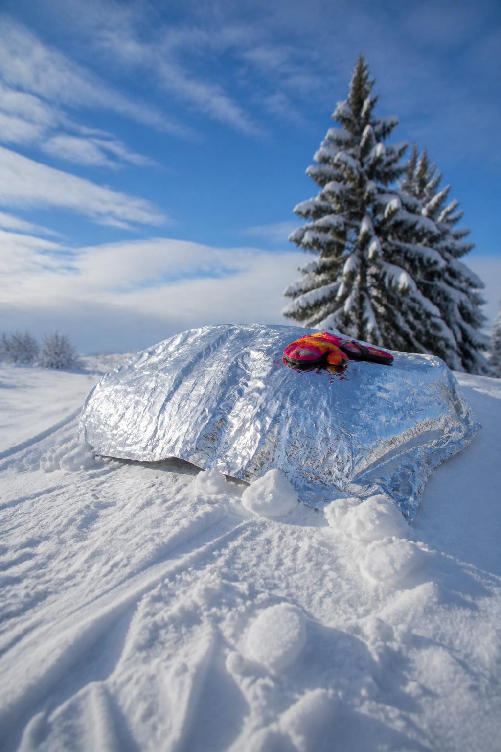 A mylar blanket used as a sled on hardpack snow.