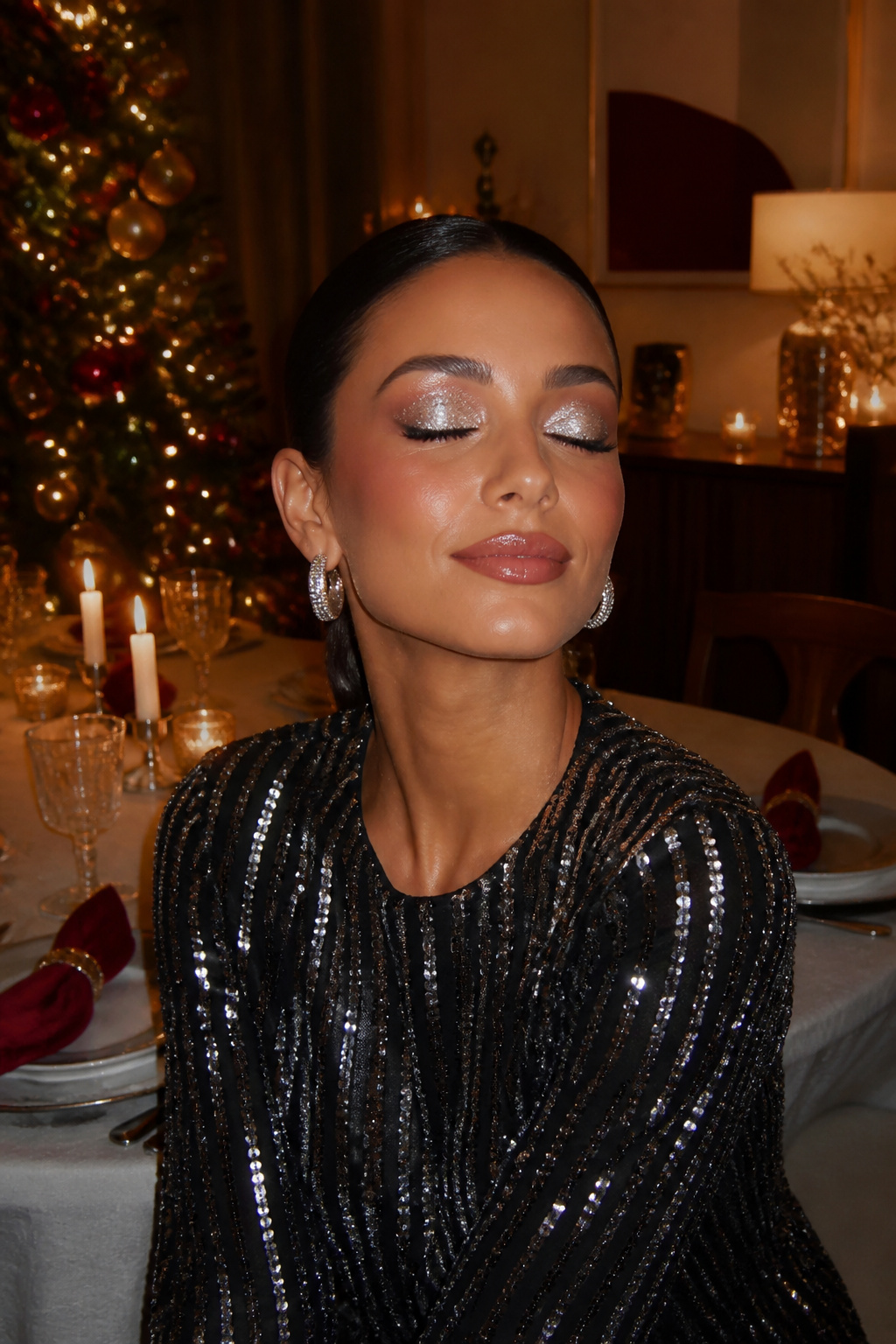 Close-up of a model's eye makeup featuring shiny silver eyelids.