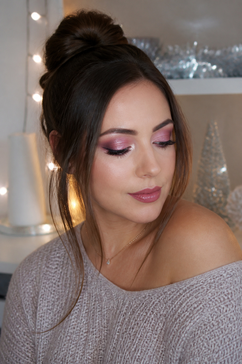 Model with mauve eyeshadow and silver accents on a pink lid.